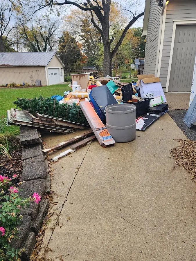 Dumpster being loaded with debris for 10 Yard Dumpster Rental in Denver